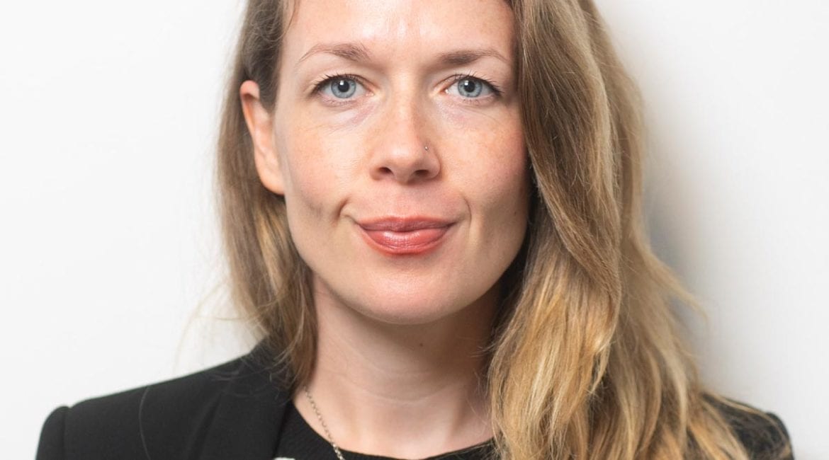 Alexandra Haselbeck wearing a black and white striped shirt.