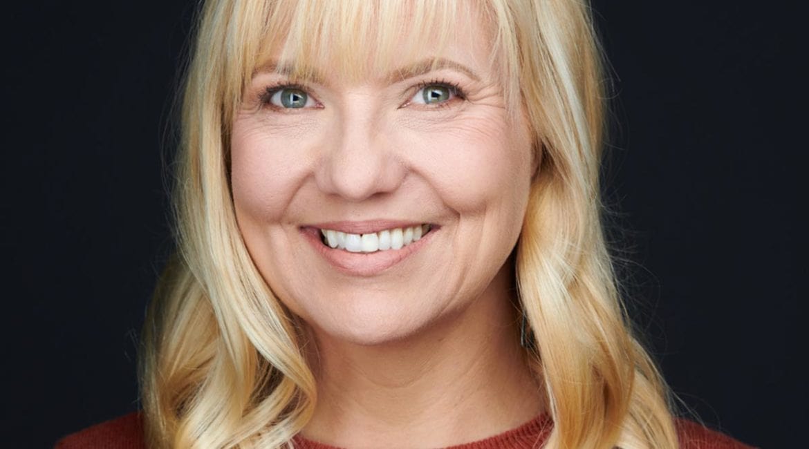 A woman named Courtney Fincher, with long blonde hair, smiling for the camera.
