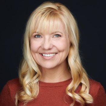 A woman named Courtney Fincher, with long blonde hair, smiling for the camera.