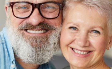 An older couple participating in a DARe Live Intensive, smiling for the camera.