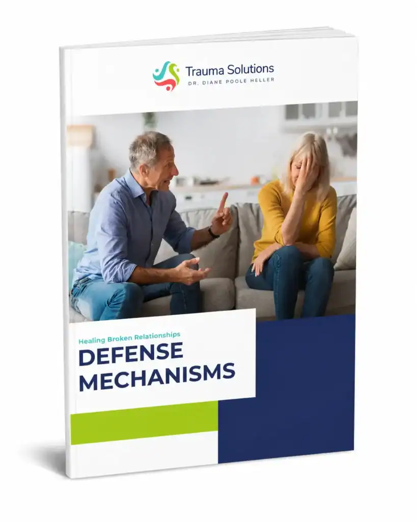 Trauma Solutions: A man gestures while talking to a woman who covers her face, sitting together on a couch; the book cover reads "Defense Mechanisms" by Trauma Solutions, Dr. Diane Poole Heller.