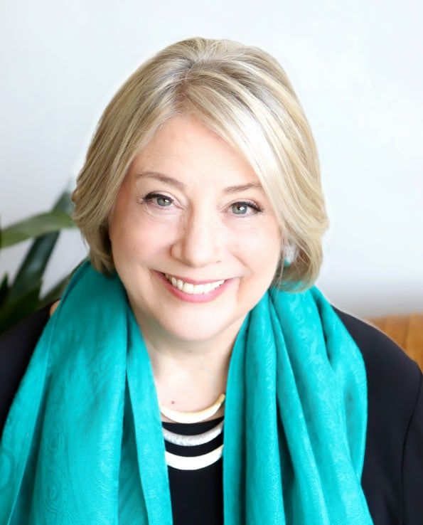 A woman wearing a turquoise scarf.