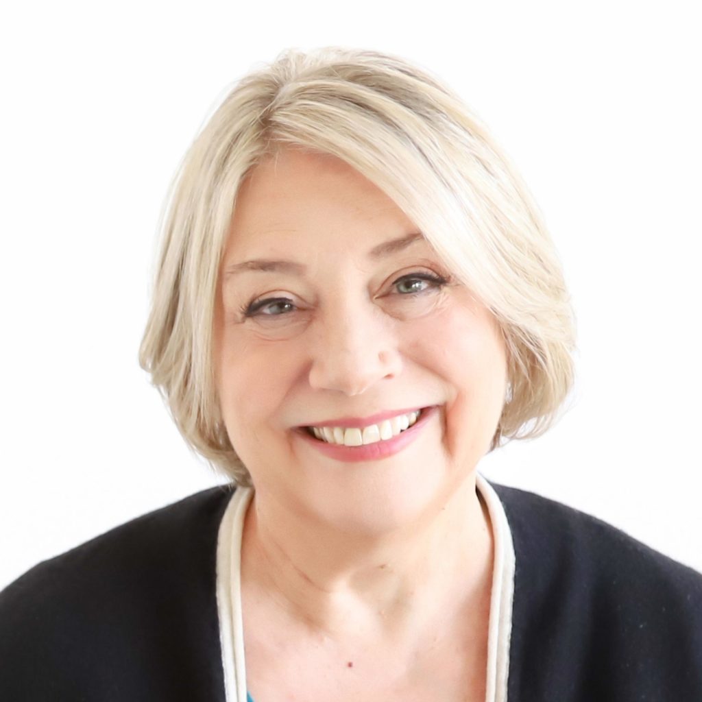 A woman with blonde hair displaying an engaging smile for the camera as part of a media kit.