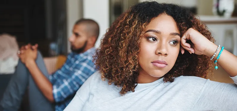 Frustrated woman looking away from her partner during a tense moment—illustrating emotional shutdown and disconnection in relationships.
