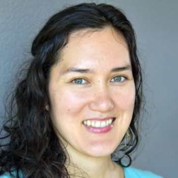 Erin Hernandez, a smiling woman wearing a blue shirt.