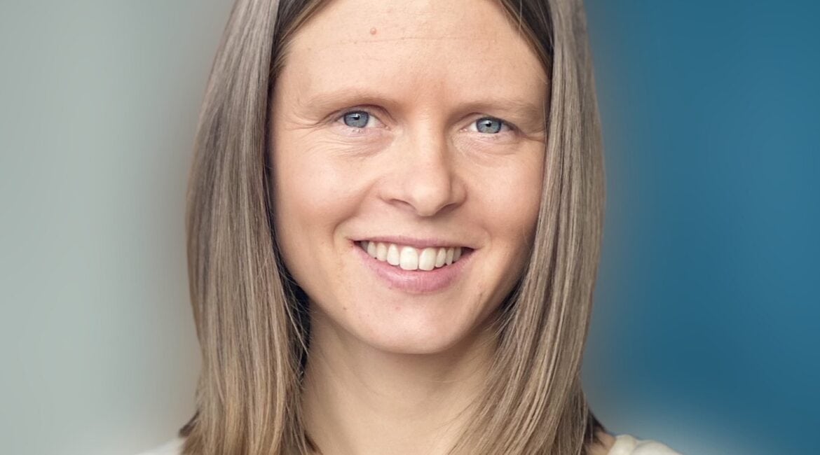 A woman with blonde hair smiling for the camera.