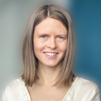 A woman with blonde hair smiling for the camera.