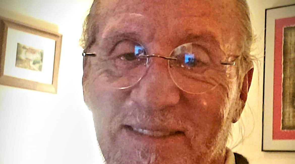 A man wearing glasses and a black jacket.