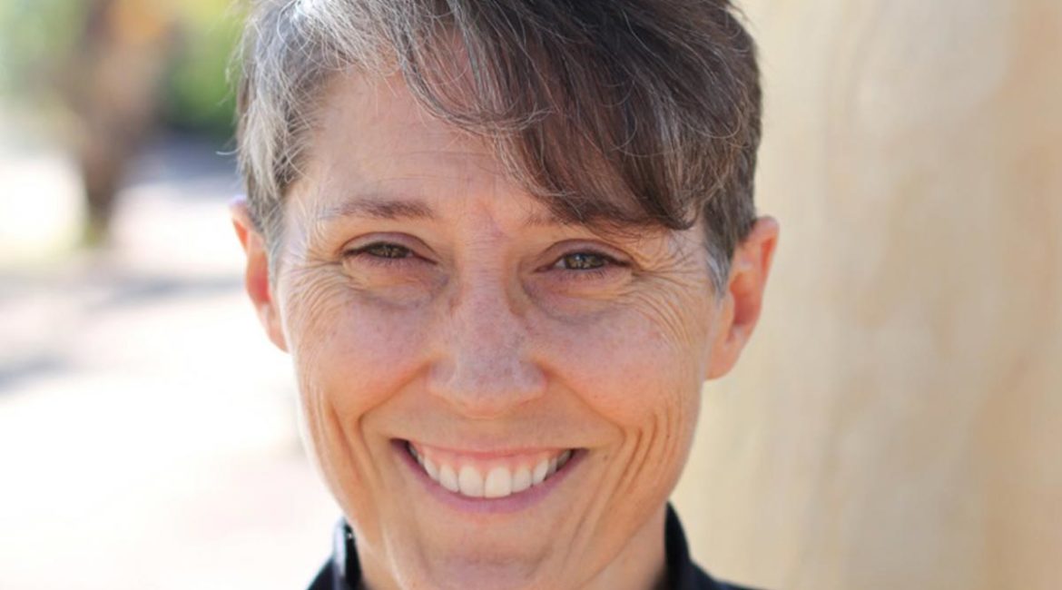 Michelle Gallagher wearing a black turtle neck shirt.