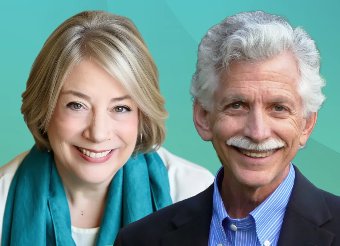Trauma Solutions: Two smiling older adults, a woman with short blonde hair and a teal scarf, and a man with curly gray hair, mustache, and a navy blazer, pose together against a teal background.