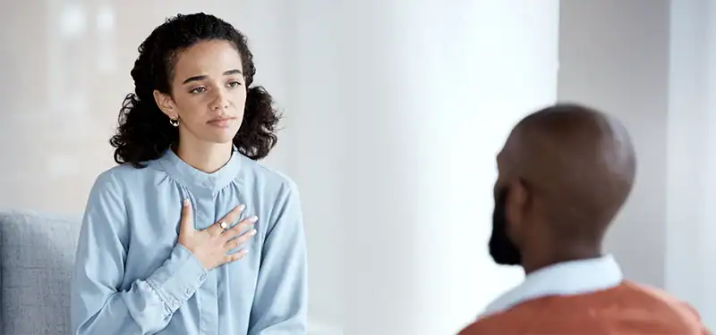 Trauma Solutions: A young woman appears empathetic toward her conversation partner. Disorganized adaptations can often feature a high capacity for empathy and understanding of others' suffering.