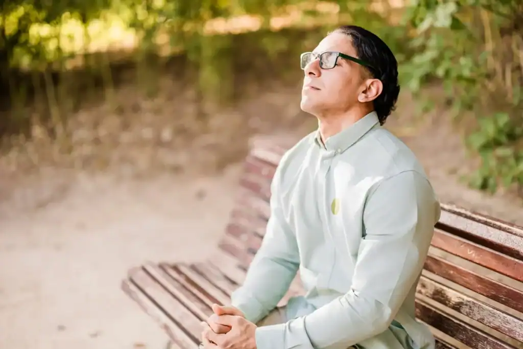 Trauma Solutions: A man sits on a bench, appearing content and safe.