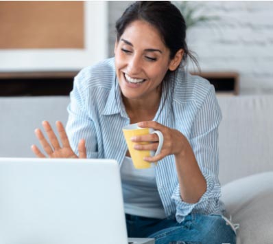 A woman is using a laptop at home.